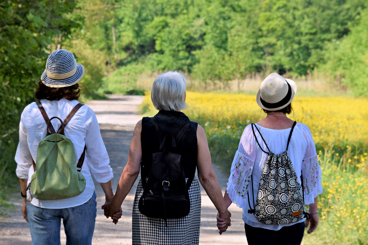 Group of women holding hands during a natural menopause management session led by Trish the Menopause Coach, focusing on holistic approaches to managing menopause symptoms